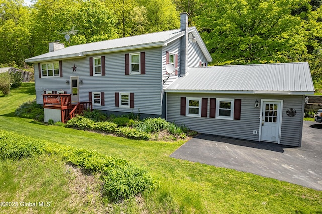 3180 Coach Rd, Hartford, NY 12809 - back of property featuring a chimney, metal roof, a patio, and a yard