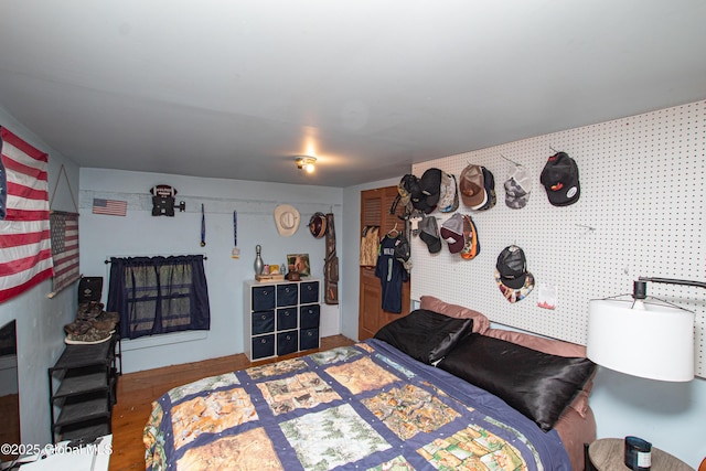 bedroom with visible vents and wood finished floors