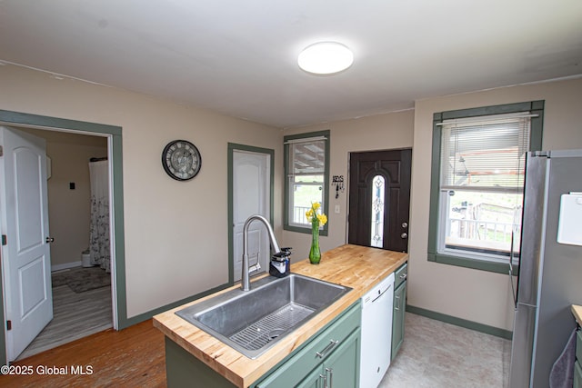130 Kelly Ln, Mohawk, NY 12068 - kitchen with freestanding refrigerator, dishwasher, wooden counters, and a sink
