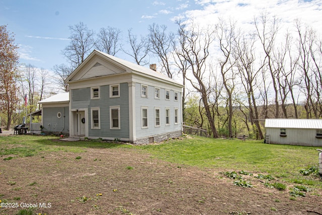 view of home's exterior featuring a yard and a chimney