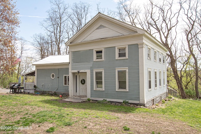 neoclassical home featuring a front yard