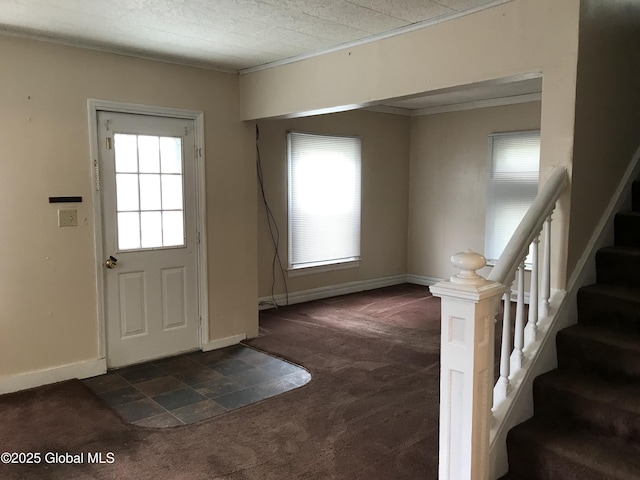23 Orville St, Glens Falls, NY 12801 - foyer entrance featuring dark colored carpet, plenty of natural light, stairs, baseboards, and ornamental molding