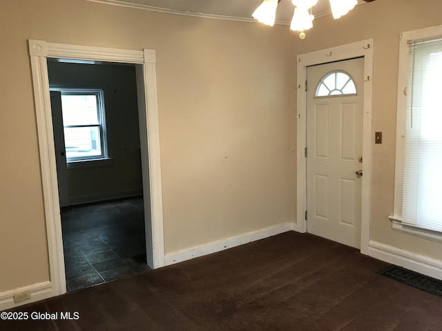 23 Orville St, Glens Falls, NY 12801 - foyer with baseboards, crown molding, and a chandelier