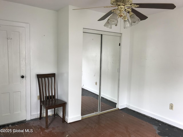 23 Orville St, Glens Falls, NY 12801 - unfurnished bedroom with baseboards, dark wood-type flooring, a closet, and a ceiling fan