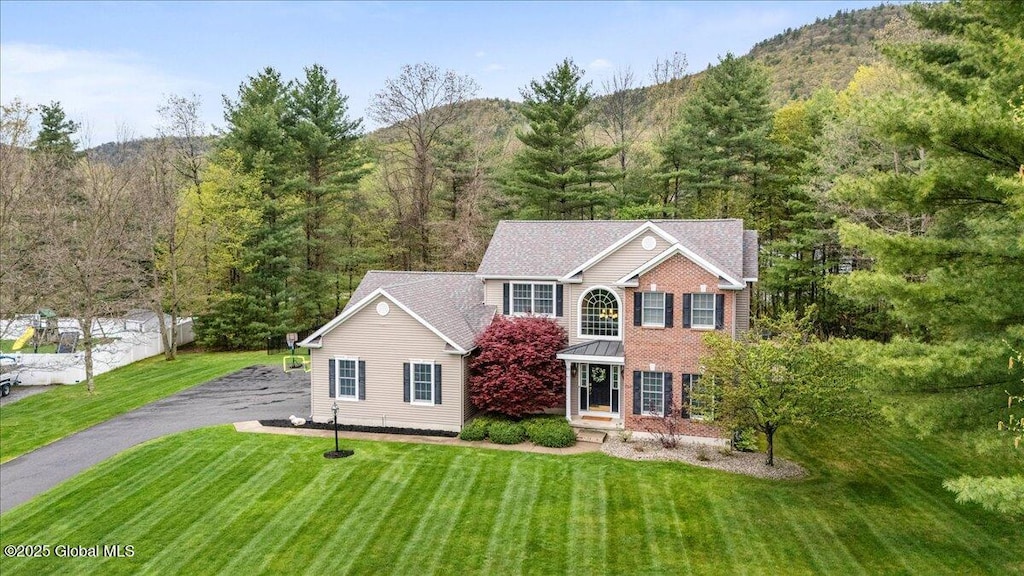 13 Noble Way, Queensbury, NY 12804 - view of front facade with a front yard, a wooded view, and a mountain view