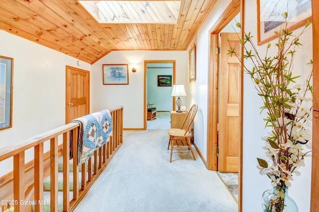 506 Nellis Rd, Palatine, NY 13339 - corridor featuring light colored carpet, wooden ceiling, a skylight, vaulted ceiling, and baseboards