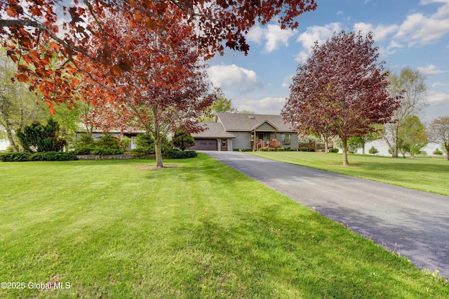 506 Nellis Rd, Palatine, NY 13339 - obstructed view of property featuring an attached garage, asphalt driveway, and a front yard