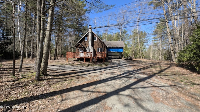 47 Davis Rd, Schroon, NY 12870 - view of front of house featuring a wooden deck, dirt driveway, and a chimney