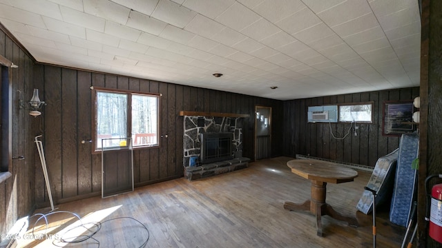 47 Davis Rd, Schroon, NY 12870 - living area with a fireplace, wood walls, baseboard heating, and wood finished floors