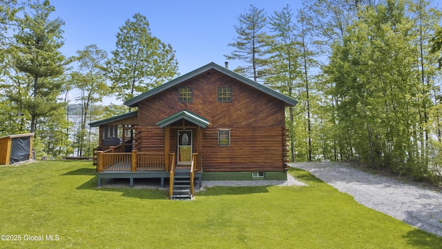 89 Captains Cv, Crown Point, NY 12928 - view of front of property featuring log siding, a front lawn, and a wooden deck