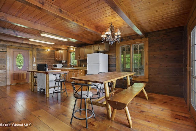 89 Captains Cv, Crown Point, NY 12928 - dining room with wooden walls, beam ceiling, hardwood / wood-style flooring, a chandelier, and wooden ceiling