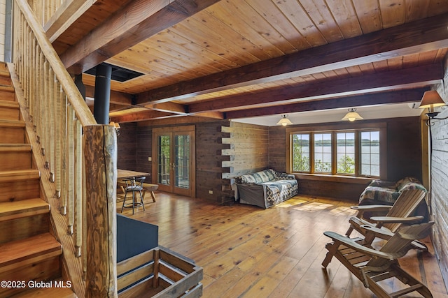 89 Captains Cv, Crown Point, NY 12928 - living room featuring wooden walls, beamed ceiling, wood ceiling, hardwood / wood-style flooring, and stairway