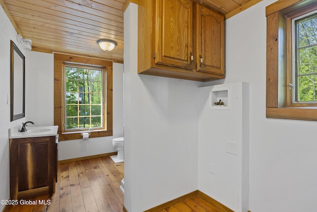 89 Captains Cv, Crown Point, NY 12928 - washroom featuring wood ceiling, cabinet space, baseboards, light wood-style floors, and washer hookup