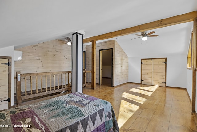 89 Captains Cv, Crown Point, NY 12928 - bedroom with vaulted ceiling, wooden walls, hardwood / wood-style flooring, baseboards, and ceiling fan