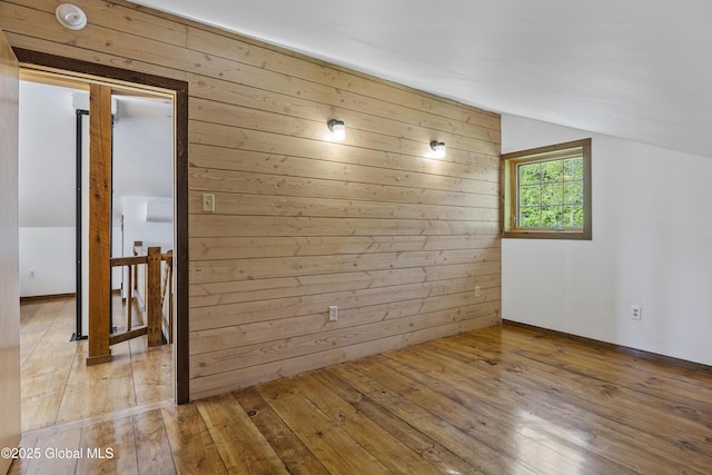 89 Captains Cv, Crown Point, NY 12928 - spare room featuring lofted ceiling, wooden walls, light wood finished floors, and a smoke detector