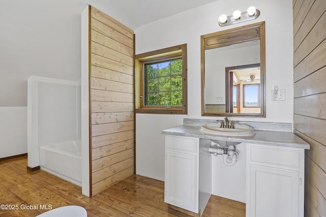 89 Captains Cv, Crown Point, NY 12928 - bathroom with vanity, a bathtub, and wood finished floors
