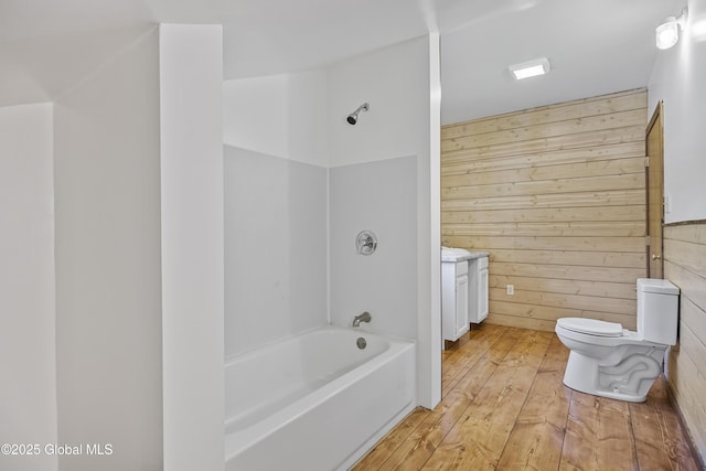 89 Captains Cv, Crown Point, NY 12928 - full bathroom featuring wooden walls, shower / tub combination, toilet, wood-type flooring, and vanity