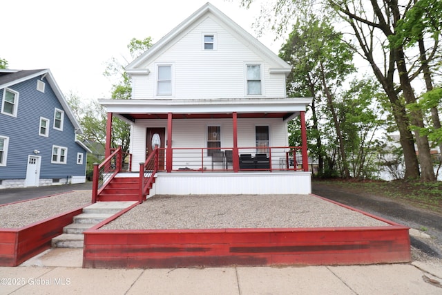 american foursquare style home featuring a porch