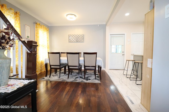 dining room featuring stairway, wood finished floors, and ornamental molding