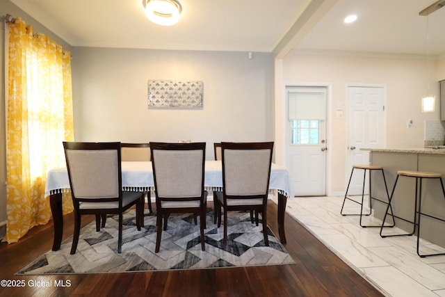 dining room featuring ornamental molding and baseboards