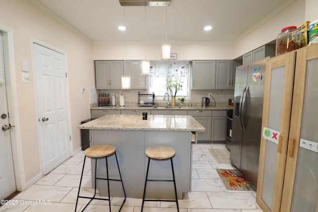 kitchen with gray cabinets, light marble finish flooring, crown molding, and recessed lighting