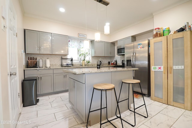 kitchen with gray cabinetry, light marble finish flooring, a kitchen bar, ornamental molding, and recessed lighting