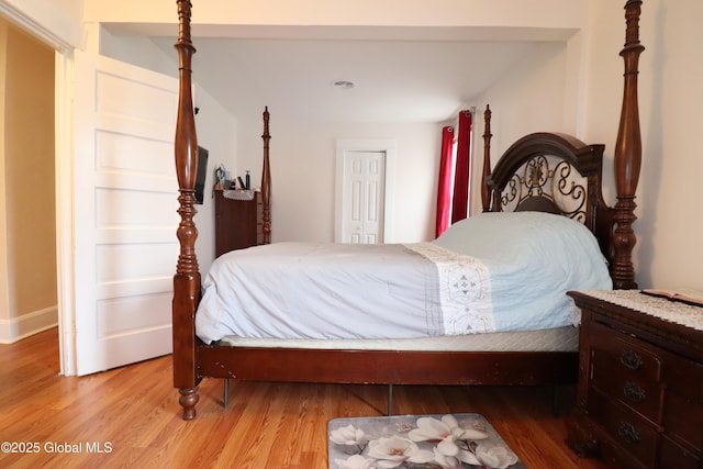 bedroom featuring light wood-style flooring and baseboards