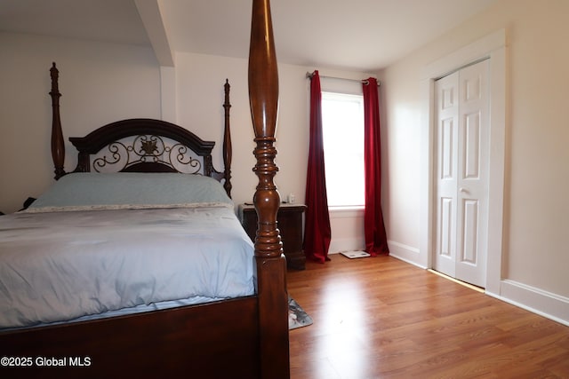 bedroom featuring wood finished floors and baseboards