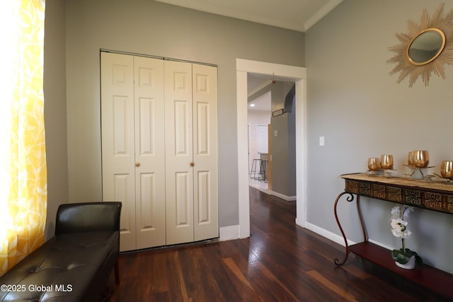 living area featuring ornamental molding, wood finished floors, and baseboards