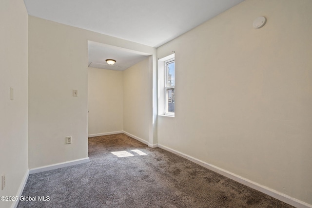 carpeted empty room with baseboards