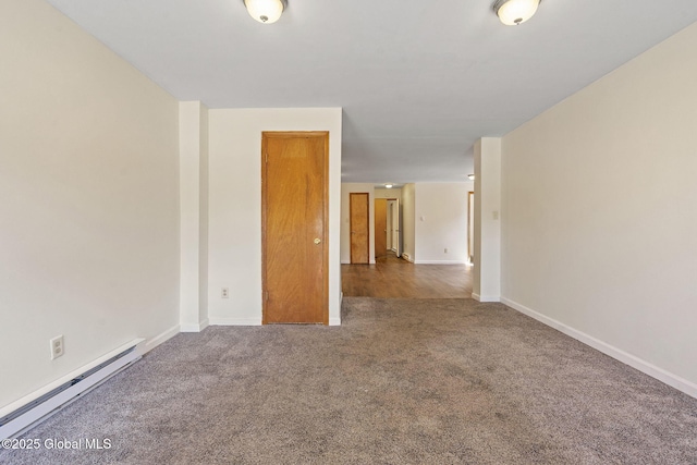 carpeted empty room with baseboards and a baseboard heating unit