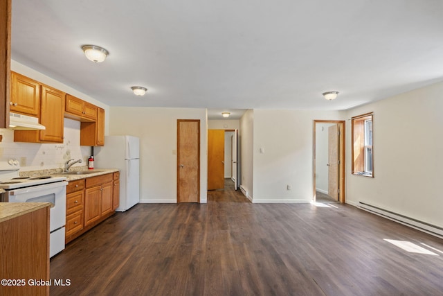 kitchen with a sink, white appliances, under cabinet range hood, light countertops, and tasteful backsplash