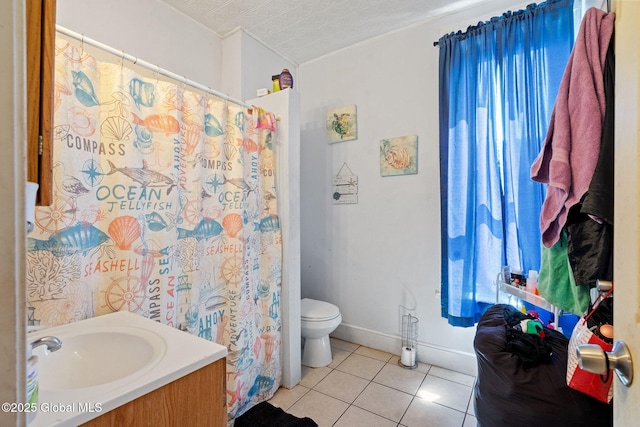 full bath with vanity, toilet, baseboards, and tile patterned floors