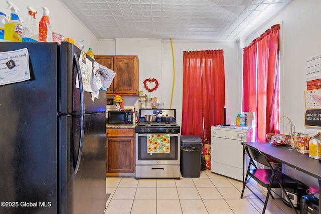kitchen with light tile patterned floors and black appliances