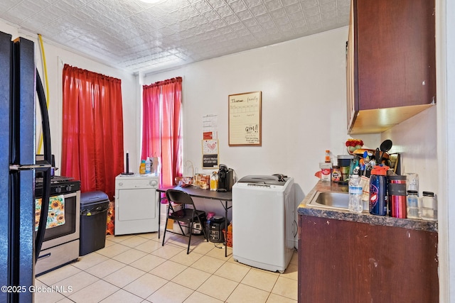 kitchen with freestanding refrigerator, an ornate ceiling, washer / dryer, and light tile patterned flooring