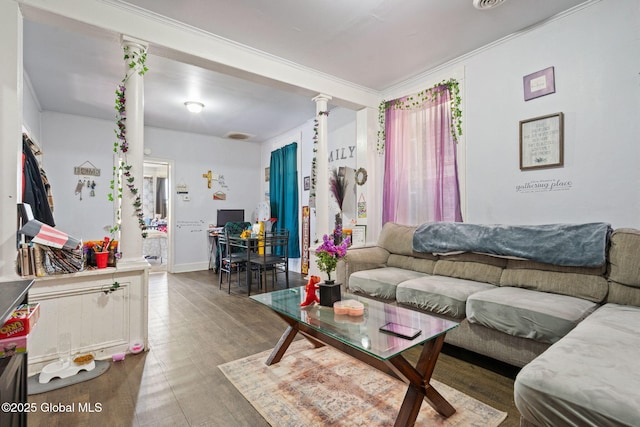 living area with wood finished floors, decorative columns, and ornamental molding