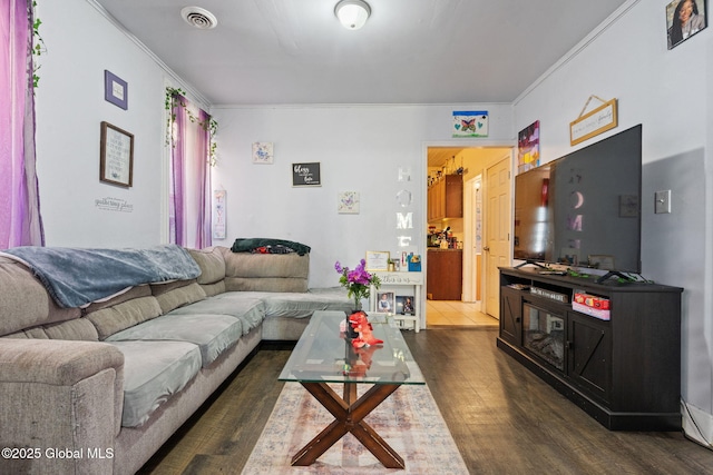 living area with crown molding, dark wood finished floors, and visible vents