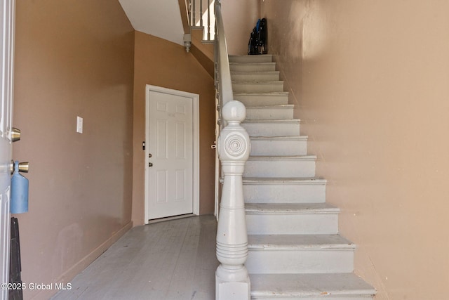 stairway with wood finished floors
