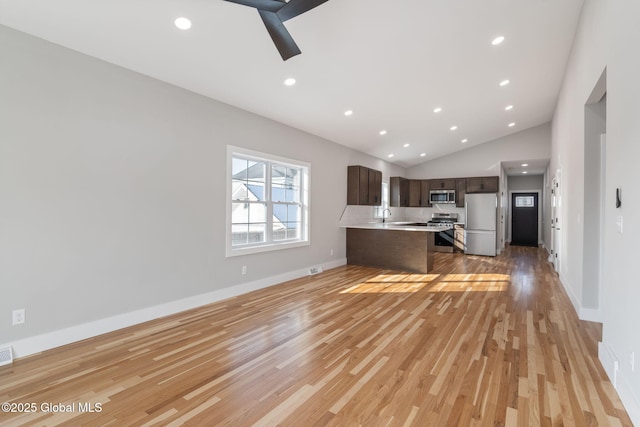 kitchen with light countertops, appliances with stainless steel finishes, dark brown cabinetry, and recessed lighting