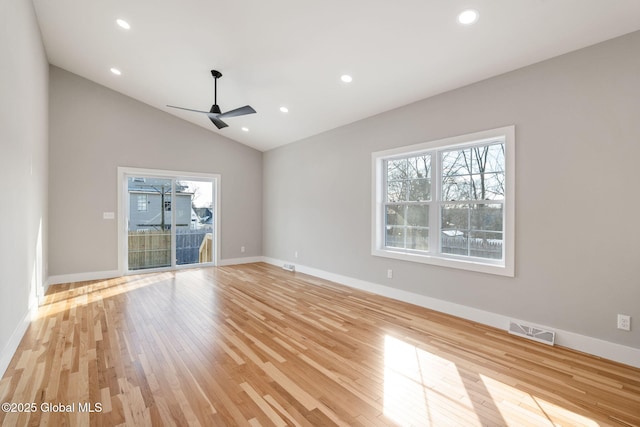 unfurnished room with ceiling fan, light wood finished floors, a healthy amount of sunlight, and visible vents
