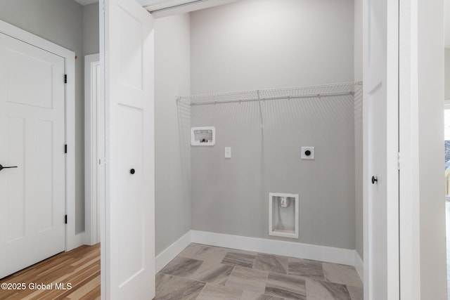 laundry room featuring laundry area, baseboards, and hookup for an electric dryer