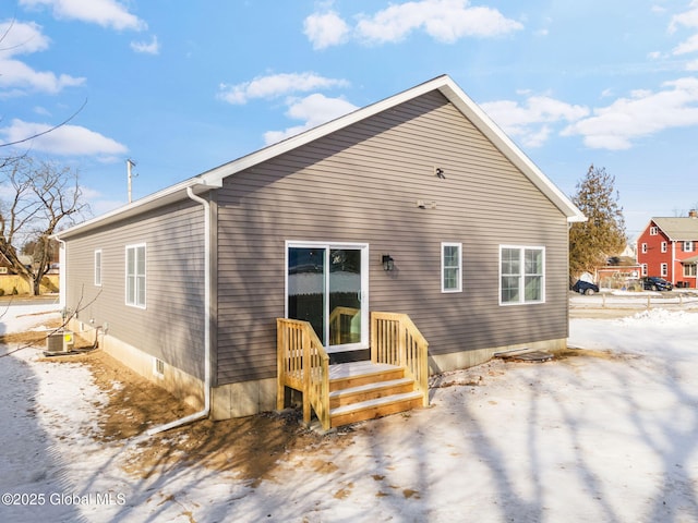 rear view of property featuring central AC unit