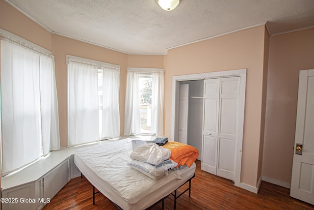 27 Kingsboro Ave, Gloversville, NY 12078 - bedroom featuring ornamental molding, a closet, a textured ceiling, and wood finished floors