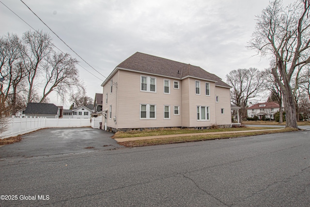 27 Kingsboro Ave, Gloversville, NY 12078 - view of home's exterior with a shingled roof, driveway, and fence