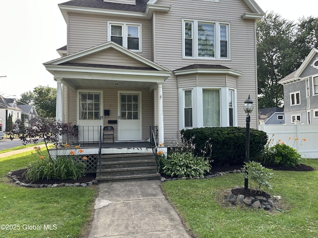 27 Kingsboro Ave, Gloversville, NY 12078 - view of front of home featuring a porch, a front lawn, and fence