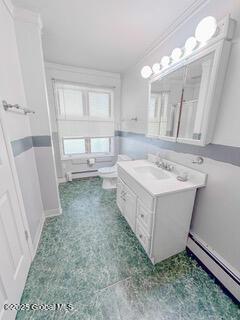 bathroom featuring vanity, toilet, baseboard heating, and a baseboard heating unit