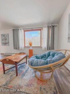 sitting room with baseboards and wood finished floors