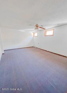interior space with carpet and ceiling fan