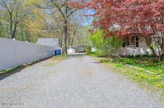view of road with gravel driveway