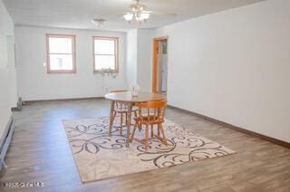 dining room with baseboards and wood finished floors